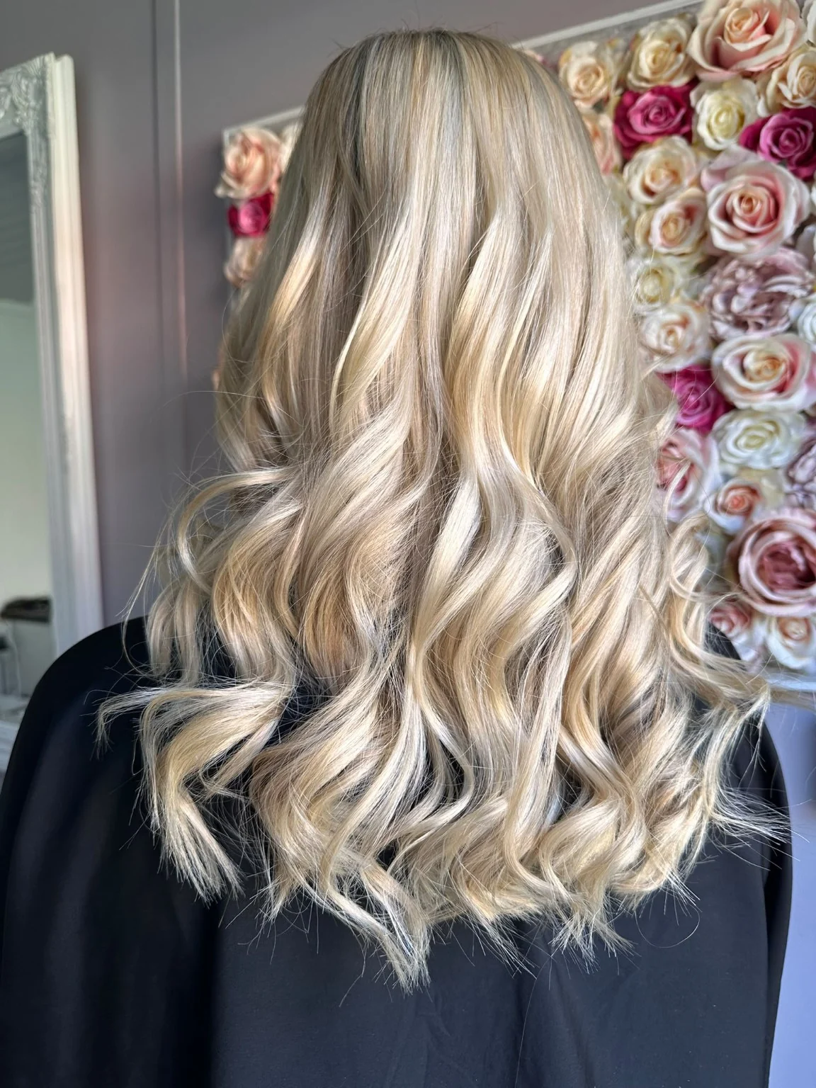 Long light blonde hair styled in flowing waves